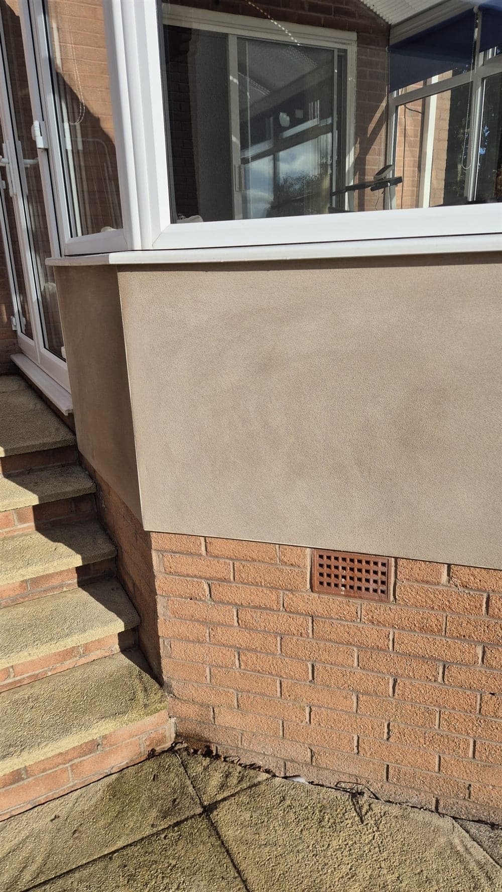 Freshly rendered bay window plinth with a clean, sharp finish